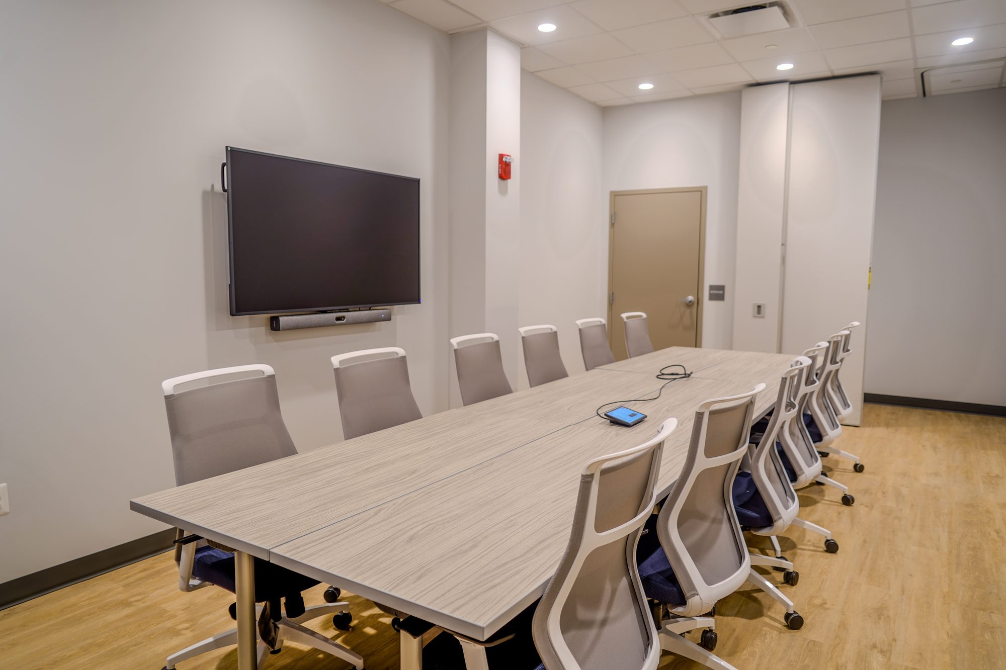Conference room with a wall display and integrated audio, designed and installed by NET-AV